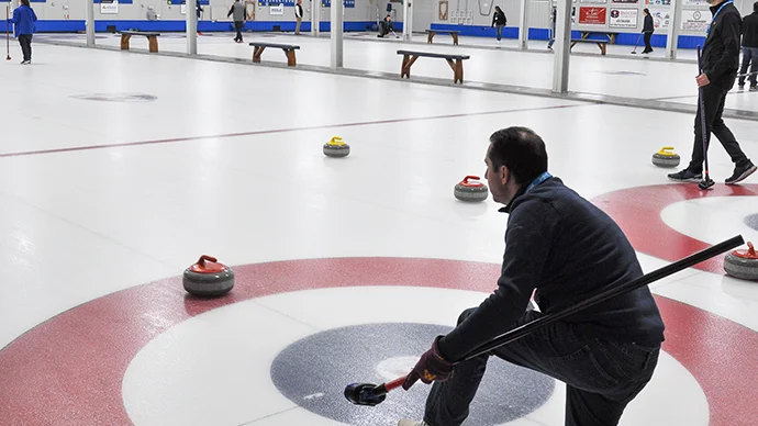 photo of people playing curling